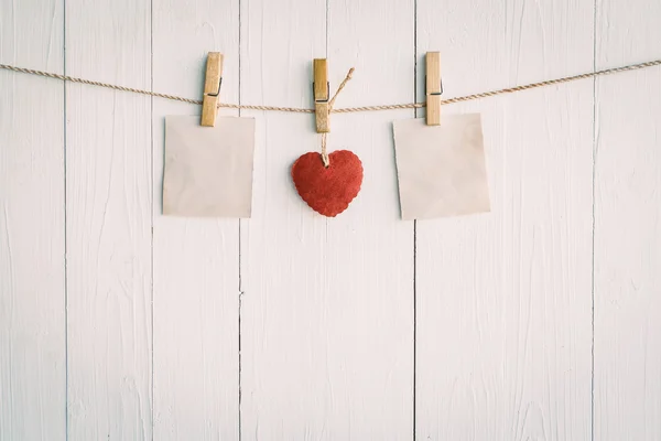 Two blank old paper and red heart hanging. On white wooden backg — Stock Photo, Image