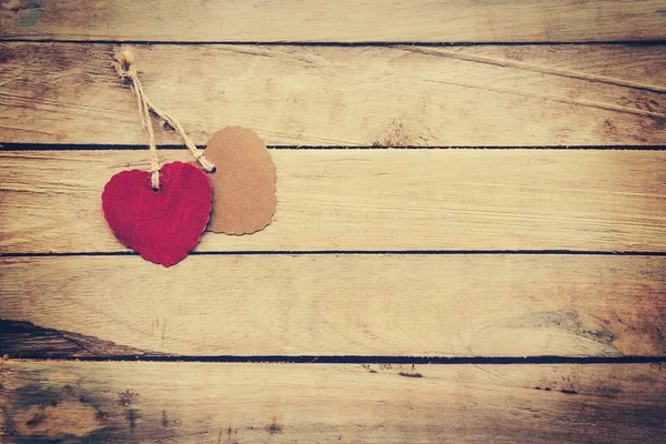 Two red and brown heart on wooden background with vintage style. — Stock Photo, Image