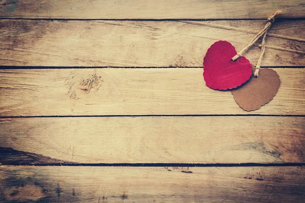 Two red and brown heart on wooden background with vintage style. — Stock Photo, Image