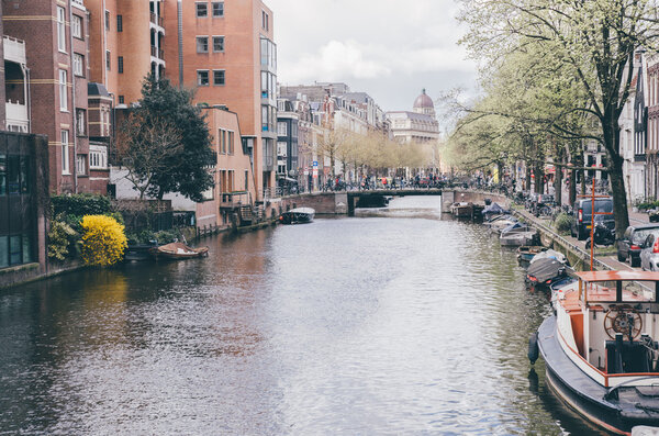 Amsterdam canal with boat, spring atmosphere