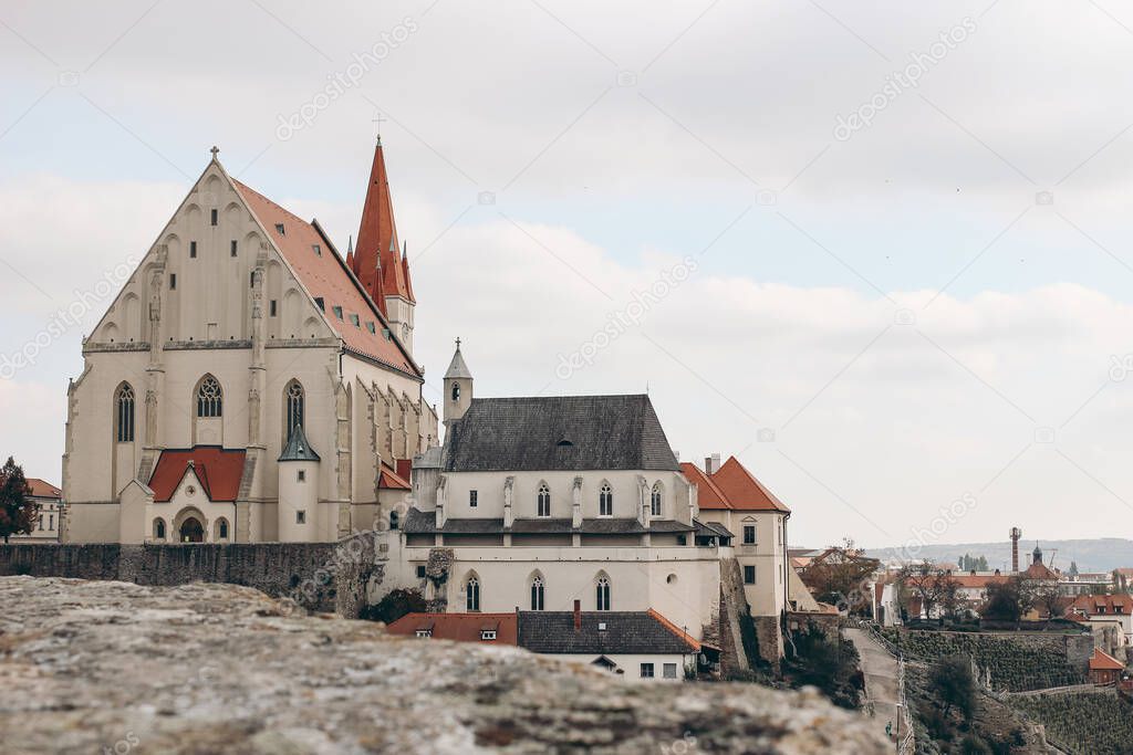 Panorama of Znojmo town, South Moravia, Czech Republic, Europe. View of old red roofs and houses. St. Nicholas church with tower and St. Wenceslas chapel over sky. European travel concept.