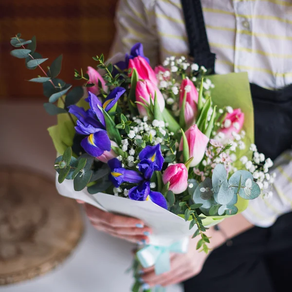 Mãos de florista mostrando buquê de flores da primavera. Foco seletivo . — Fotografia de Stock