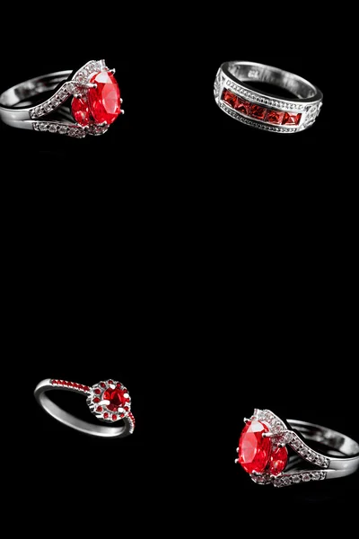 Luxury jewelry. White gold or silver engagement rings with colored gemstone closeup on black background — 图库照片