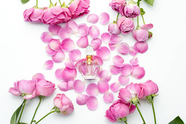 Perfume bottle with flower petals on white background. Perfumery, cosmetics, fragrance collection.