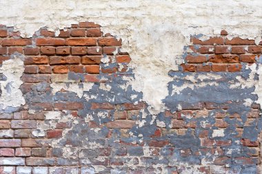 Grunge empty red stonewall background. Old brick wall texture. Painted distressed wall surface. Weathered building facade with old damaged plaster. Grungy brickwall