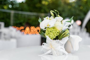 Açık hava restoranındaki masada çiçekler. Yazlık bir kafe terası. Düğün resepsiyonu ya da etkinlik için masa ayarlayın. Metin için alanı kopyala