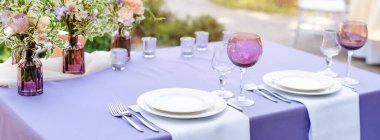 Tatiller ve düğün yemeği için çiçek masası süslemeleri. Açık hava restoranında tatil, etkinlik, parti veya düğün resepsiyonu için masa hazır.