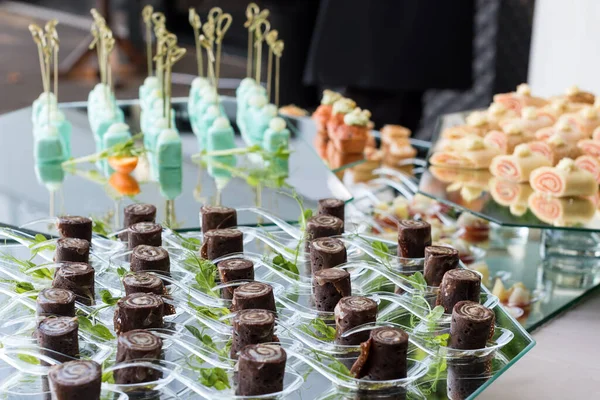 Appetizers, finger food, party food, sliders. Canape, tapas. Served table at summer terrace cafe. Catering service. Outdoor restaurant table with food