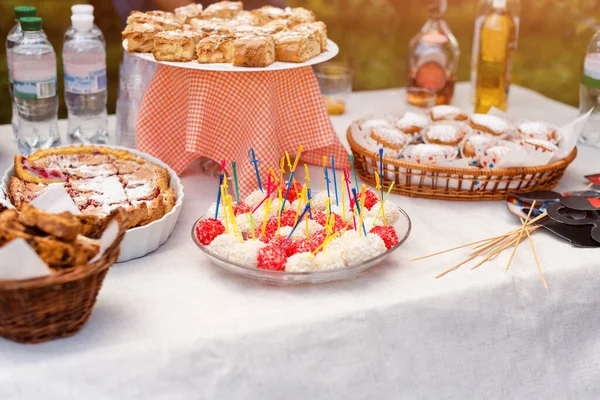 Sweet cakes, biscuits, desserts, homemade strawberry pie tart. Cake, sweet baked pastry food with sugar powder and fruits in a basket