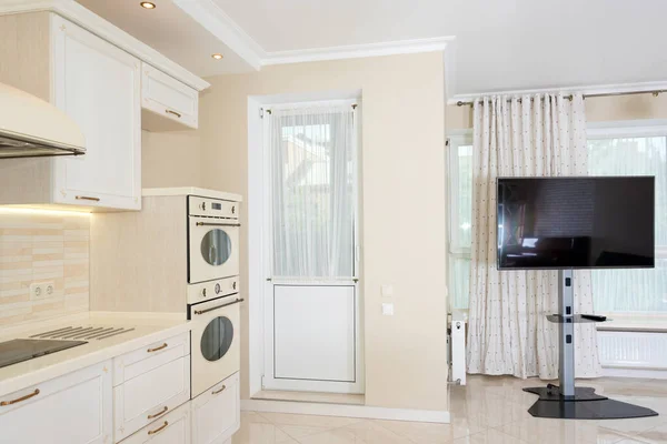 Modern kitchen area attached to the living room. Interior design with classic or vintage and modern elements