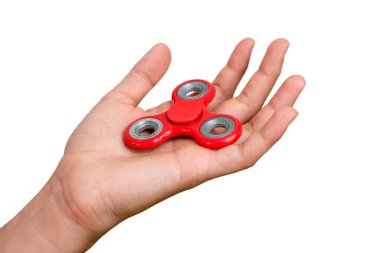 Kırmızı el hareketi. Çocuk elinde popüler bir oyuncak fırıldağı oynuyor. Stres atmak. Stres önleyici ve rahatlatıcı. İlgi çekici çocuk konsepti.