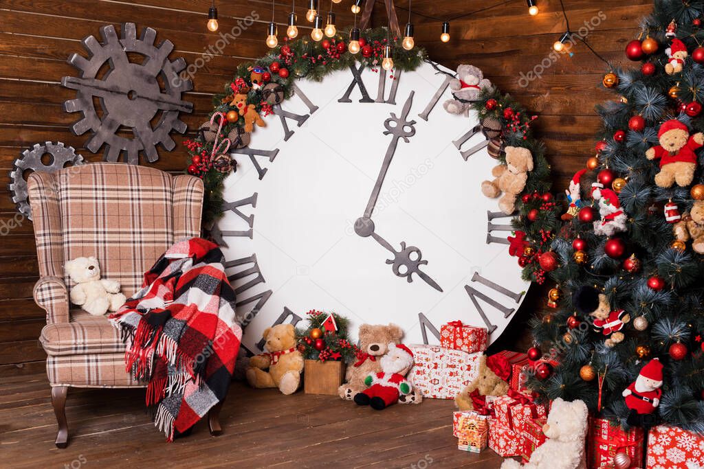Beautiful holiday decorated living room with Christmas tree and presents. Big magical clock on wooden wall. Winter holidays design and decorations background