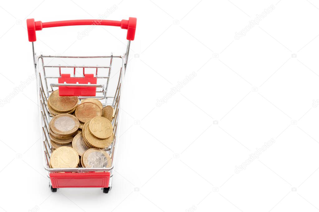 Shopping cart with euro coins in it on white background. Supermarket shopping, sale and cash back theme. Copyspace for text