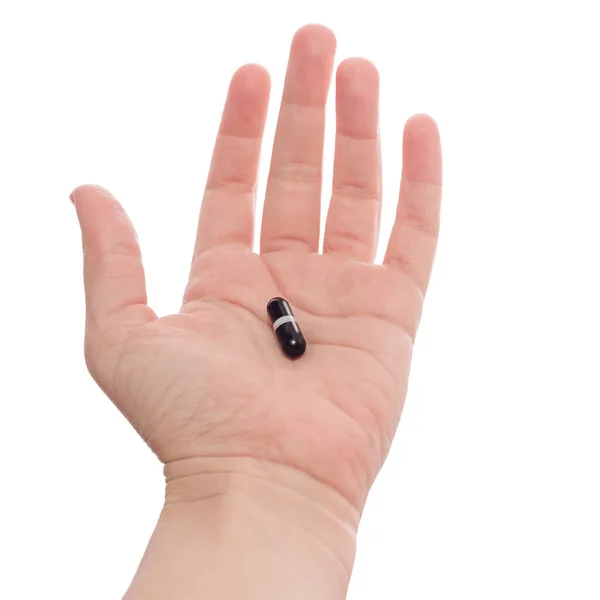 Mano Sosteniendo Ofreciendo Cápsula Negra Aislado Sobre Fondo Blanco Medicamentos —  Fotos de Stock