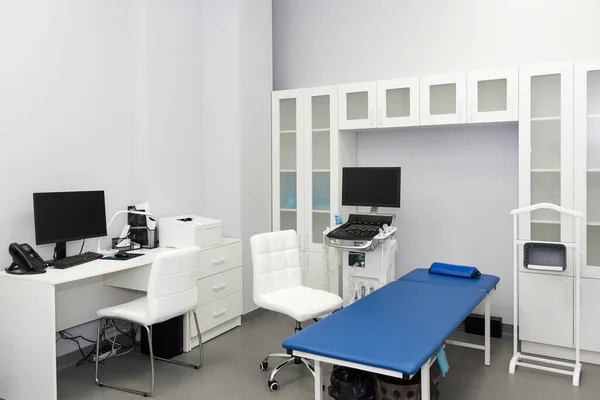 Interior of examination room with ultrasonography machine in hospital laboratory. Modern medical equipment background