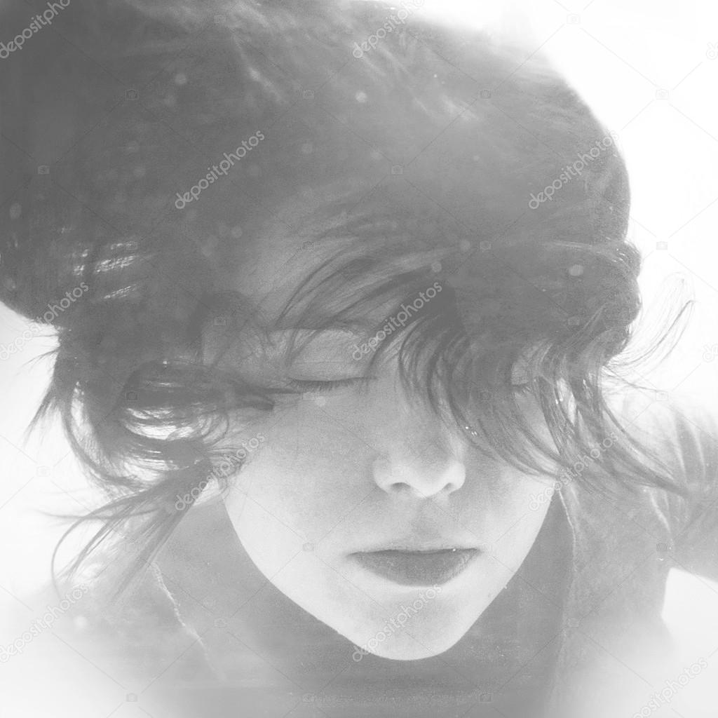 Diving girl. Mermaid face with hair floating in water. Black and white retro stylized underwater photography.