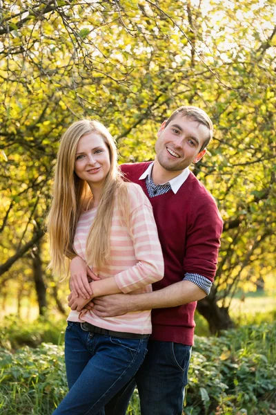 Young couple in love outdoor. Happy people in love walking in the woods hugging each other, having a spring mood and enjoying life — Stock Photo, Image