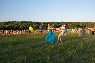 Birlikte yaz açık havada arka plan üzerinde dans iki mutlu kız.