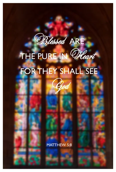 Inspirational religious quote with words Blessed are the pure of heart on background of stained-glass window inside the church.