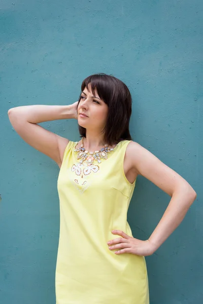 Beauty portrait pretty woman in the city summer posing near an old colorful wall. — Stock Photo, Image