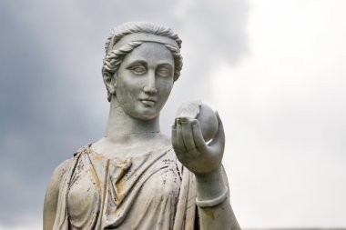 Marble statue of the Greek goddess Hera or the Roman goddess Juno, holding an apple of discord in the park of the Palace and park complex Estate of G. Galagan. Sokyryntsi village, Ukraine. clipart