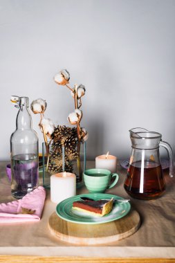 Ahşap masa arka plan üzerinde renkli plaka üzerinde lezzetli çikolatalı mousse kek parçası. Çay partisi için Tablo ayarı. Seçici odak.