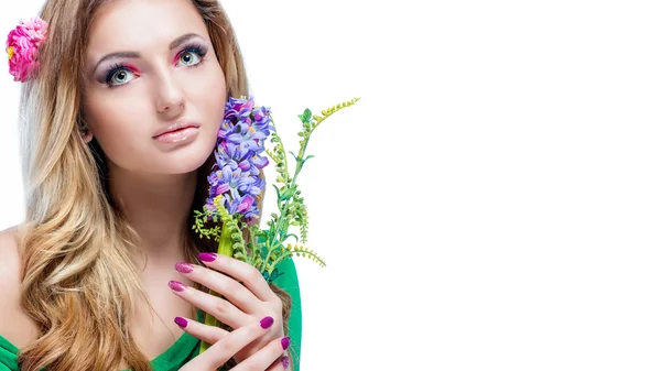 Beautiful blonde girl with bright makeup, long curled hair and massive jewelry holding a blossoming branch isolated on white background. Fashion shot. — Stock Photo, Image