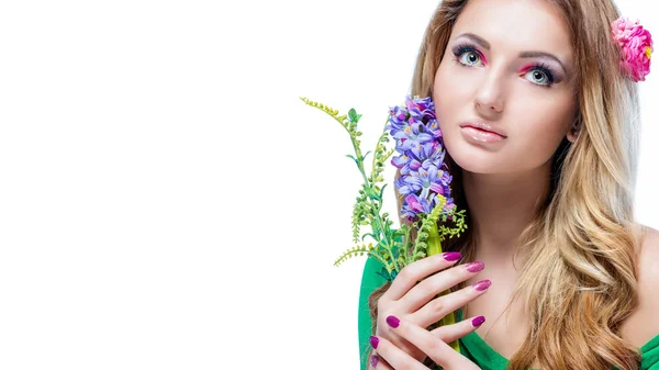 Beautiful blonde girl with bright makeup, long curled hair and massive jewelry holding a blossoming branch isolated on white background. Fashion shot. — Stock Photo, Image