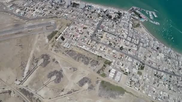 Aerial view of coastal city, small airport and ocean shore from parachute — Wideo stockowe
