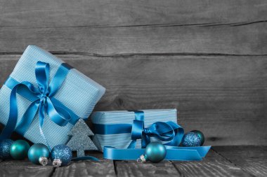 Blue christmas presents on wooden grey shabby background. clipart