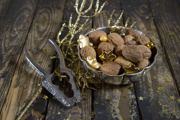 Old silver bowl mit walnuts and nutcracker for christmas. — Stock Photo, Image