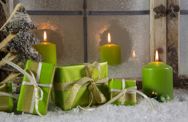 Πράσινο ξύλινα χριστουγεννιάτικα στολίδια με τα δώρα και τα κεριά. — Φωτογραφία Αρχείου