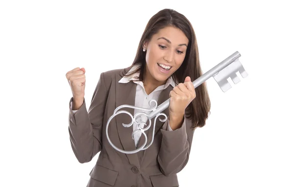 Cheering isolated woman holding key for her home in hands. — Stock Photo, Image