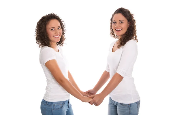 Portrait of real twin sisters isolated over white. — Stock Photo, Image