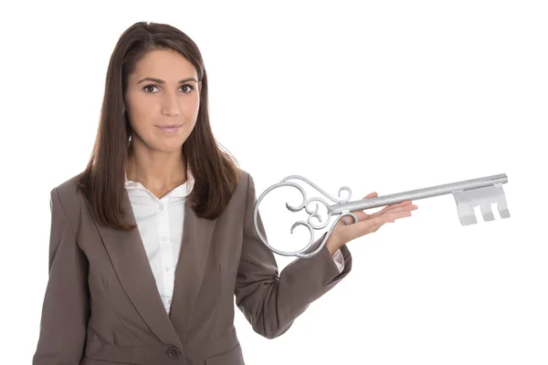 Isolated business woman holding key for a housewarming party in — Stock Photo, Image