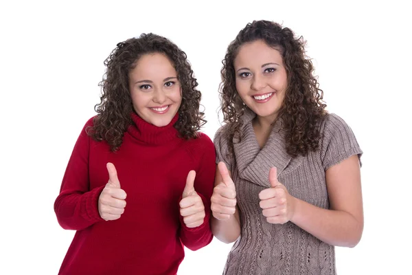 Feliz gemelo niñas haciendo el pulgar hacia arriba gesto sobre fondo blanco . — Foto de Stock