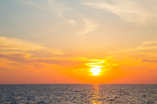 Sunset on the ocean with horizon for an atmospheric background.