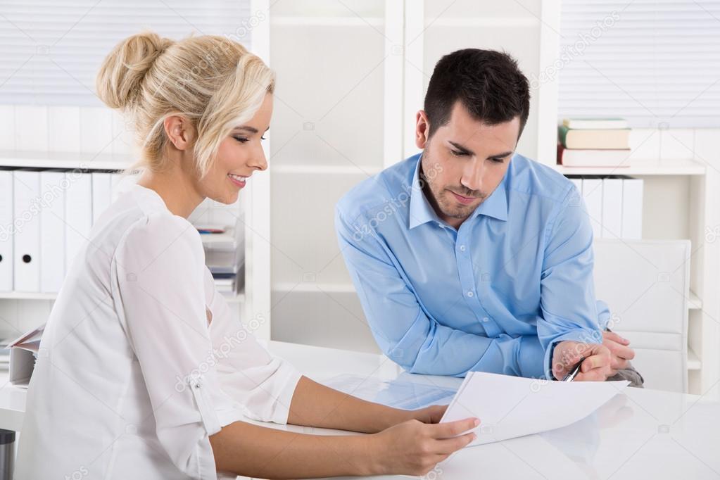 Customer and client sitting at desk or business people talking a