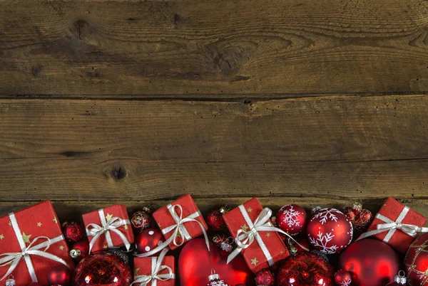 Christmas frame or border with red presents on wooden old backgr — Stock Photo, Image