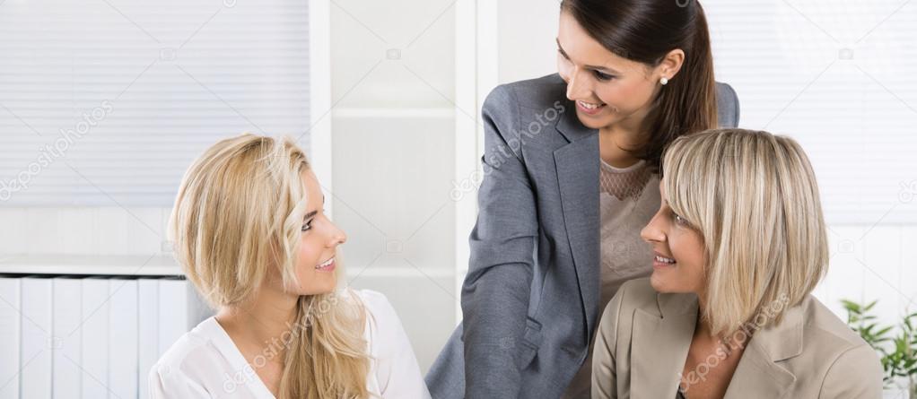 Team: Successful business team of woman in the office talking to