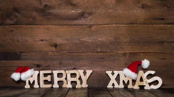 Veselé Vánoce písmena na dřevěné pozadí: nápad na pozdrav auto — Stock fotografie