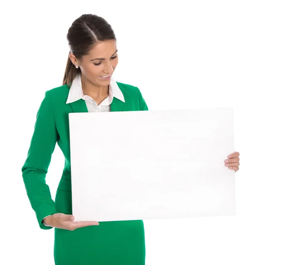 Isolated professional businesswoman in green holding white sign — Stock Photo, Image