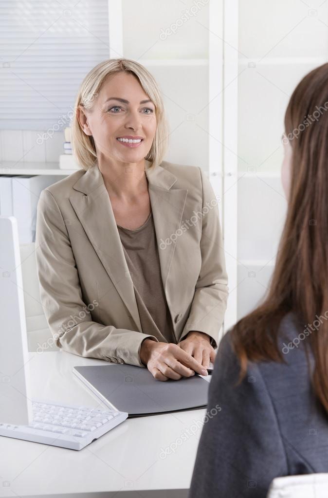 Female managing director in a job interview with a young woman.