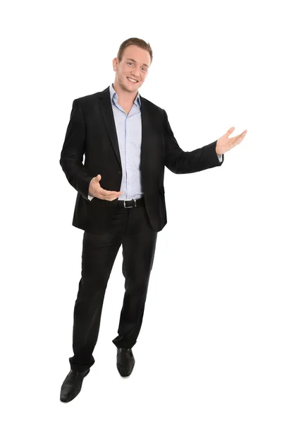 Handsome happy isolated young businessman presenting with hands. Royalty Free Stock Photos