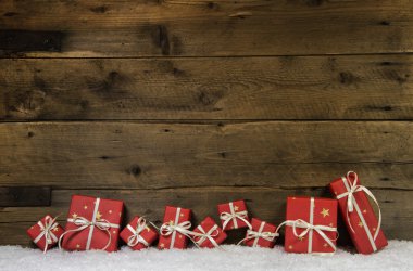Wooden rustic background with red christmas presents. clipart