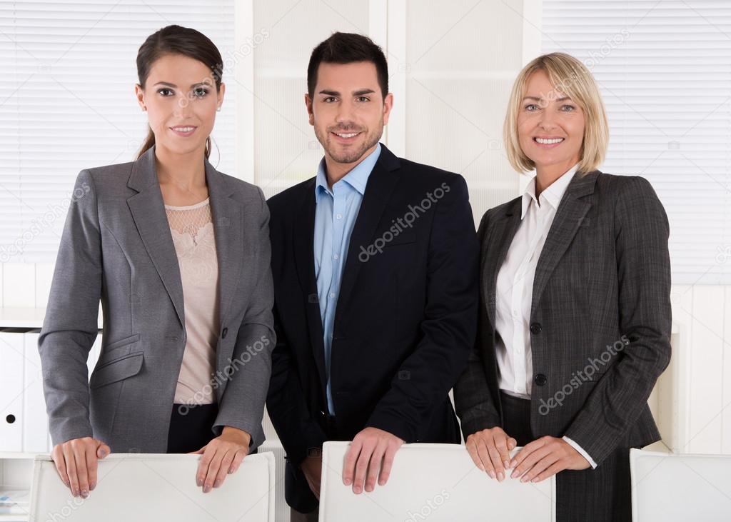 Portrait of three business people: man and woman in a team.