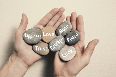 Inner balance concept: hands holding stones with the words happi clipart