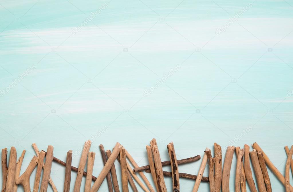 Blue or turquoise oceanic background with a fence of driftwood f