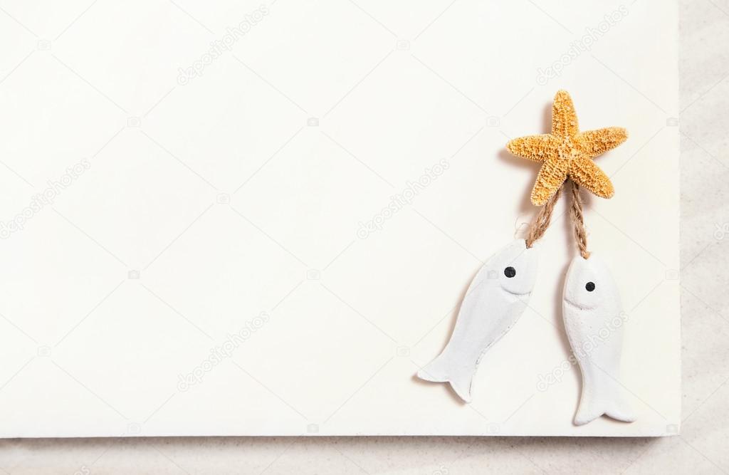 Two white fishes with starfish on a white summer background for 