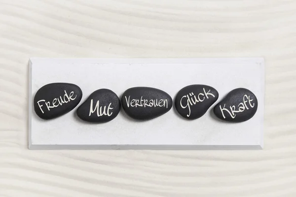 Ive μαύρες πέτρες με το κείμενο στη γερμανική γλώσσα για την ευτυχία, θάρρος, εμπιστοσύνη, — Φωτογραφία Αρχείου